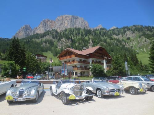 a group of vintage cars parked in front of a building at Hotel Borest in Colfosco