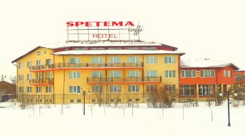 a building with a sign on top of it in the snow at Elite Spetema Hotel in Sofia