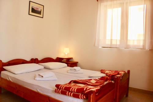 a bedroom with two beds and a window at Nir Apartments Budva in Budva