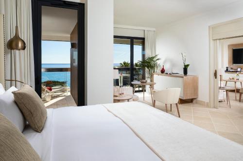 a bedroom with a bed and a view of the ocean at Hotel Don Pepe Gran Meli&aacute; in Marbella