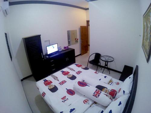 a bedroom with a bed with pillows on it at Amaryllis Guesthouse Syariah in Pacitan