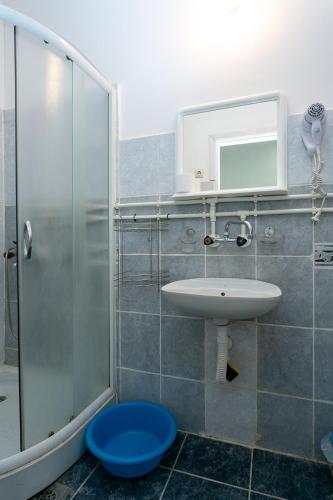 a bathroom with a sink and a shower at Apartments Ozren in Soko Banja