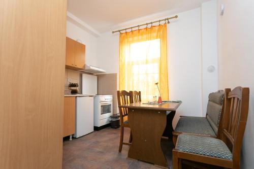 a kitchen with a table and a dining room at Apartments Ozren in Soko Banja