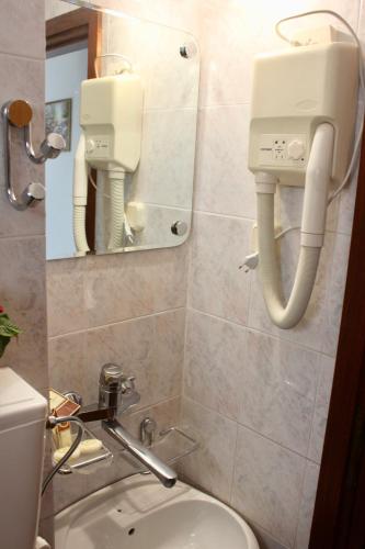 a bathroom with a sink and a toilet and a mirror at Nir Apartments Budva in Budva
