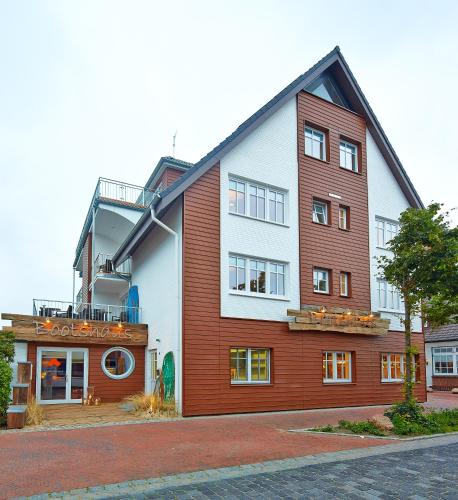 a building with a red and white at Bernstein-Hotel Bootshaus in Büsum