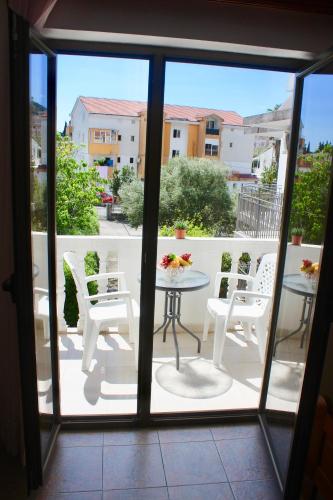 a view of a balcony with a table and chairs at Nir Apartments Budva in Budva
