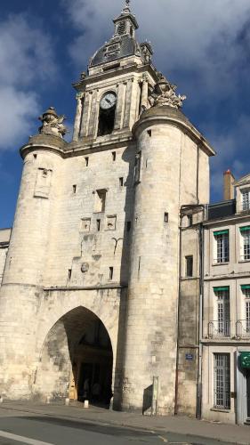 a building with a clock tower on top of it at Les Trémières in Le Thou