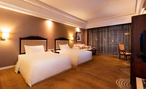 Ένα ή περισσότερα κρεβάτια σε δωμάτιο στο Country Garden Phoenix Hotels Shenyang Yuhong