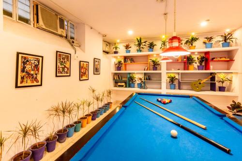 a pool table in a room with plants at goSTOPS Lite Jaipur in Jaipur