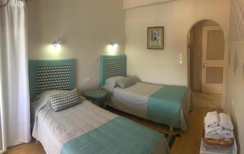 a room with two beds in a room at Tango Apartment On The Beach in Paleokastritsa
