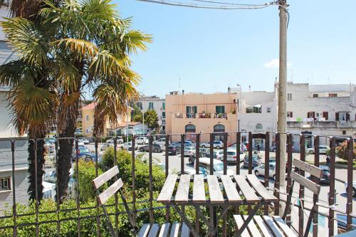a table and chairs on a balcony with a parking lot at I Tre Cardilli in Matera