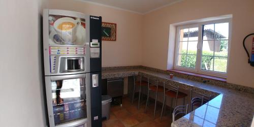 a kitchen with a stainless steel refrigerator and a counter at Hotel Alvaro frente Palacio-Museo Selgas in Cudillero