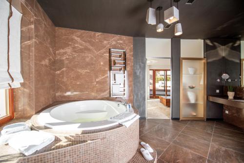 a bathroom with a bath tub in a room at Grand Hotel Lviv Casino & Spa in Lviv