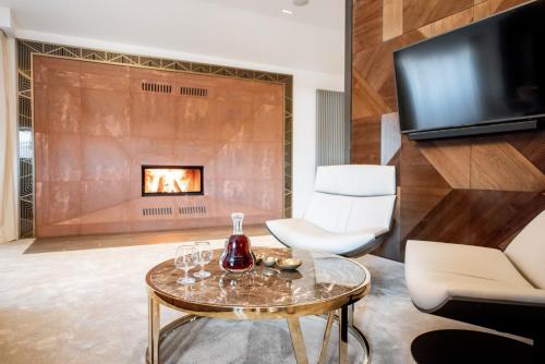 a living room with a fireplace and a table at Grand Hotel Lviv Casino & Spa in Lviv