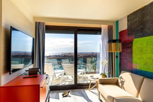 a living room with a large window overlooking the ocean at Novotel Monte-Carlo in Monte Carlo