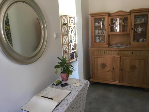 a room with a table with a mirror and a cabinet at Klause am grünen Hof in Friesoythe