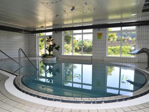 a large swimming pool in a building at Familienhotel Reiterhof Runding in Runding