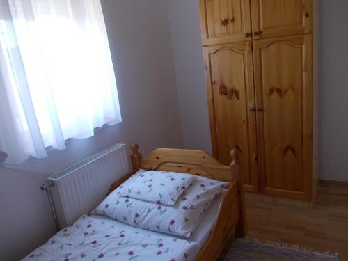 a small bedroom with a bed and a dresser at Anna villa in Lenti