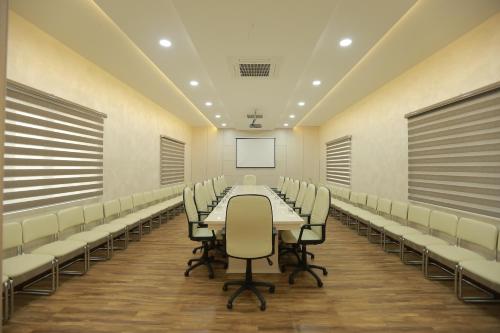 a conference room with a long table and chairs at Hotel Uzbekistan in Urganch