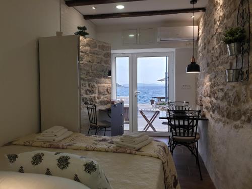 two beds in a room with a view of the ocean at Sea Star in Tribunj