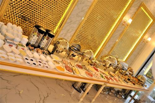 a counter with plates of food and a mirror at Hotel Uzbekistan in Urganch