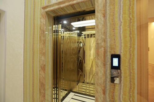 a hallway with a glass door with at Hotel Uzbekistan in Urganch