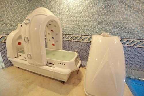 a bathroom with a sink and a urinal at Hotel Uzbekistan in Urganch