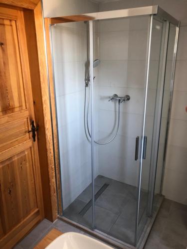 a shower with a glass door in a bathroom at Chalupa Vrchlabi in Vrchlabí