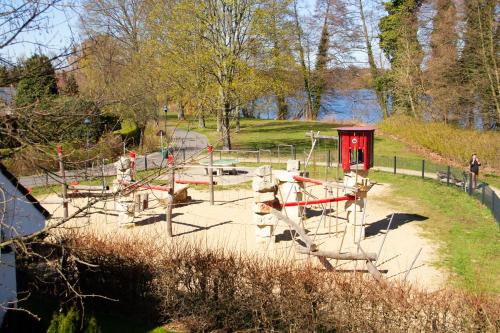 a playground in a park next to a body of water at Hotel Altes Fährhaus in Berlin