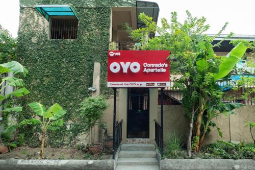 a sign in front of a building at Conrado's Apartelle in Manila