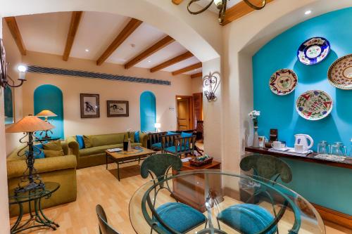 a living room with a glass table and chairs at Sun-n-Sand Mumbai Juhu Beach in Mumbai