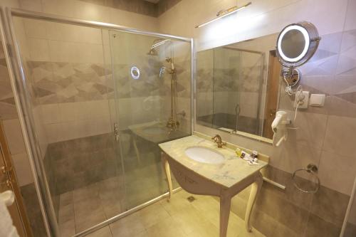 a bathroom with a sink and a shower at Hotel Uzbekistan in Urganch