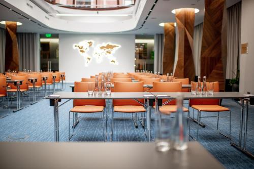 a conference room with tables and orange chairs at Grand Hotel Lviv Casino & Spa in Lviv