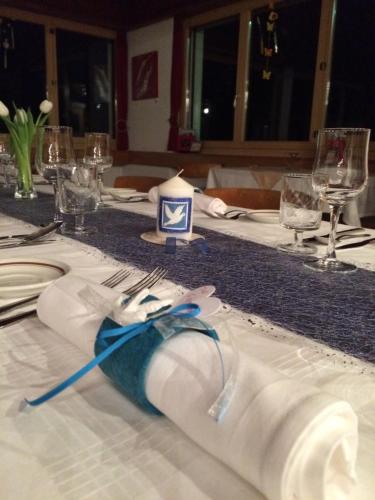 a table with a white table cloth with a candle on it at Hotel Restaurant Emshorn in Oberems