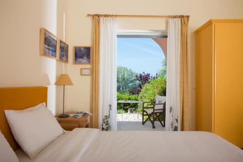 a bedroom with a bed and a door to a patio at Eleonas hotel in Rovies