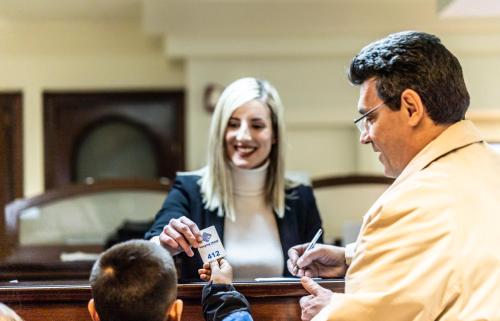 a man and a woman talking to a child at Vergina Hotel in Thessaloniki