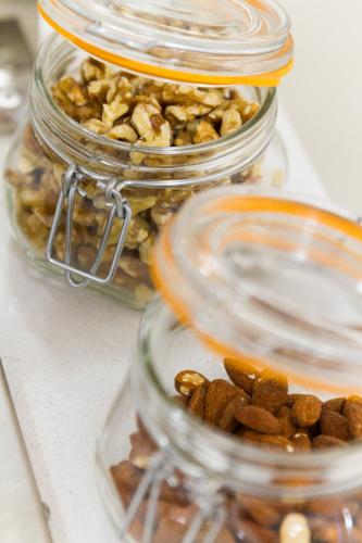 three glass jars filled with nuts on a table at Oca Playa de Foz Hotel & Spa in Foz