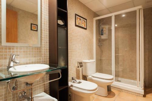 a bathroom with a toilet and a sink and a shower at Vacaciones Tossa de Mar in Tossa de Mar