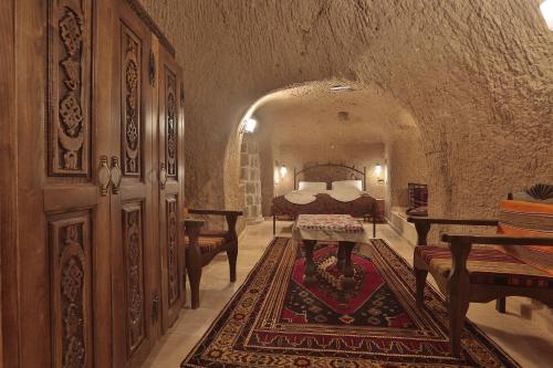 a bedroom with a bed and a rug in a room at Yoruk Stone House in Nevsehir