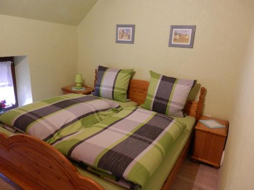 a bedroom with two beds with green and purple at Ferienhaus Greta in Malborn