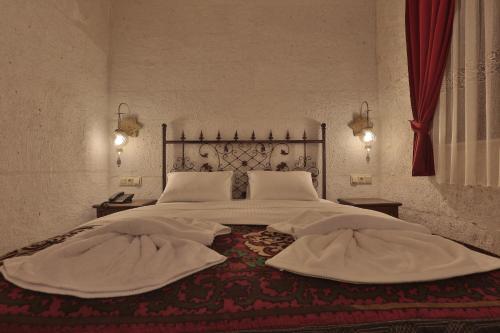 a bedroom with a large bed with two white pillows at Yoruk Stone House in Nevsehir
