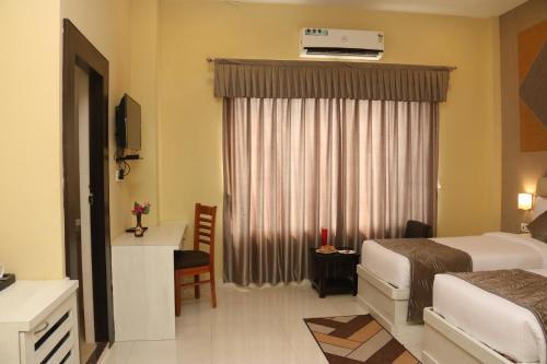 a hotel room with a bed and a window at GenX Mirzapur in Mirzāpur
