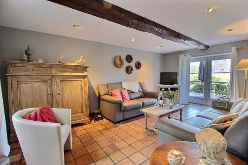 a living room with a couch and a table at Gîte Le Charme du Passé in Havelange
