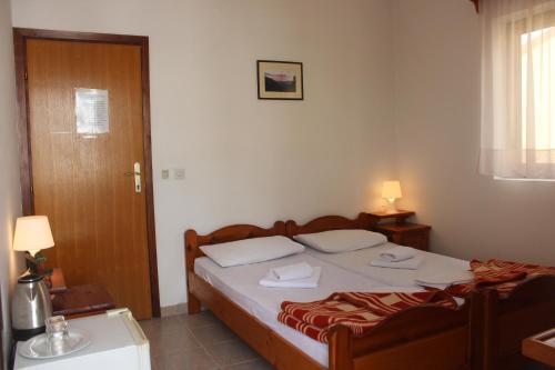 a bedroom with a bed with two towels on it at Nir Apartments Budva in Budva
