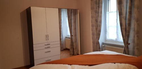 a bedroom with a bed and a dresser and a window at Apartement-Gîte rural à 3 km de Delémont in Courcelon