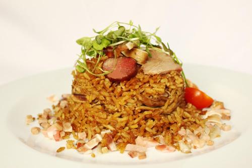 a plate of food with rice and meat and vegetables at Hotel do Elevador in Braga