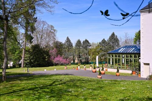 a park with a gazebo and plants in a yard at Chateau de la Rozelle in Cellettes