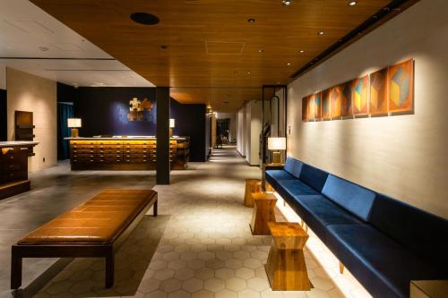 a waiting room with benches in a restaurant at The Royal Park Canvas - Ginza 8 in Tokyo