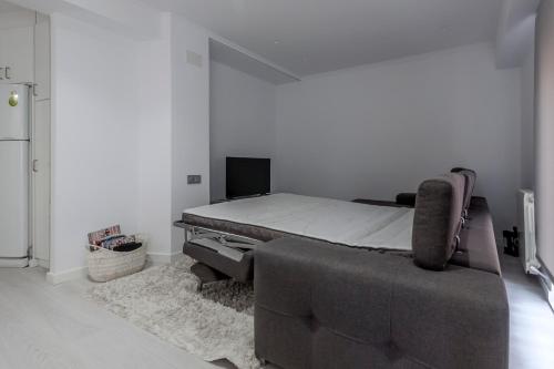 a bedroom with a bed and a couch at Carmen Apartment in Valencia