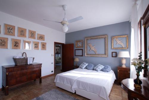 a bedroom with a white bed and blue walls at Agriturismo Santa Barbara in Mira
